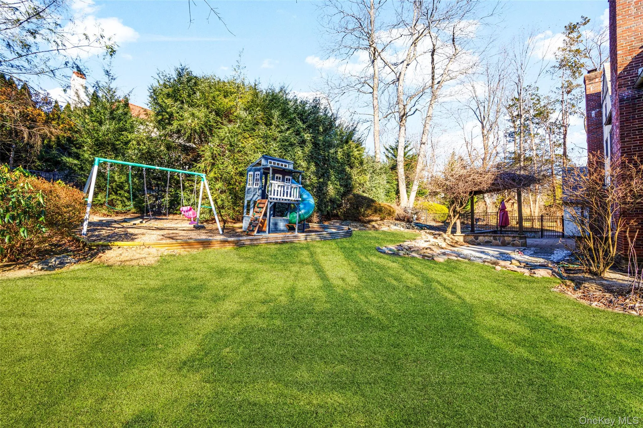 Back yard with play set and shed. Back yard with play set and shed.