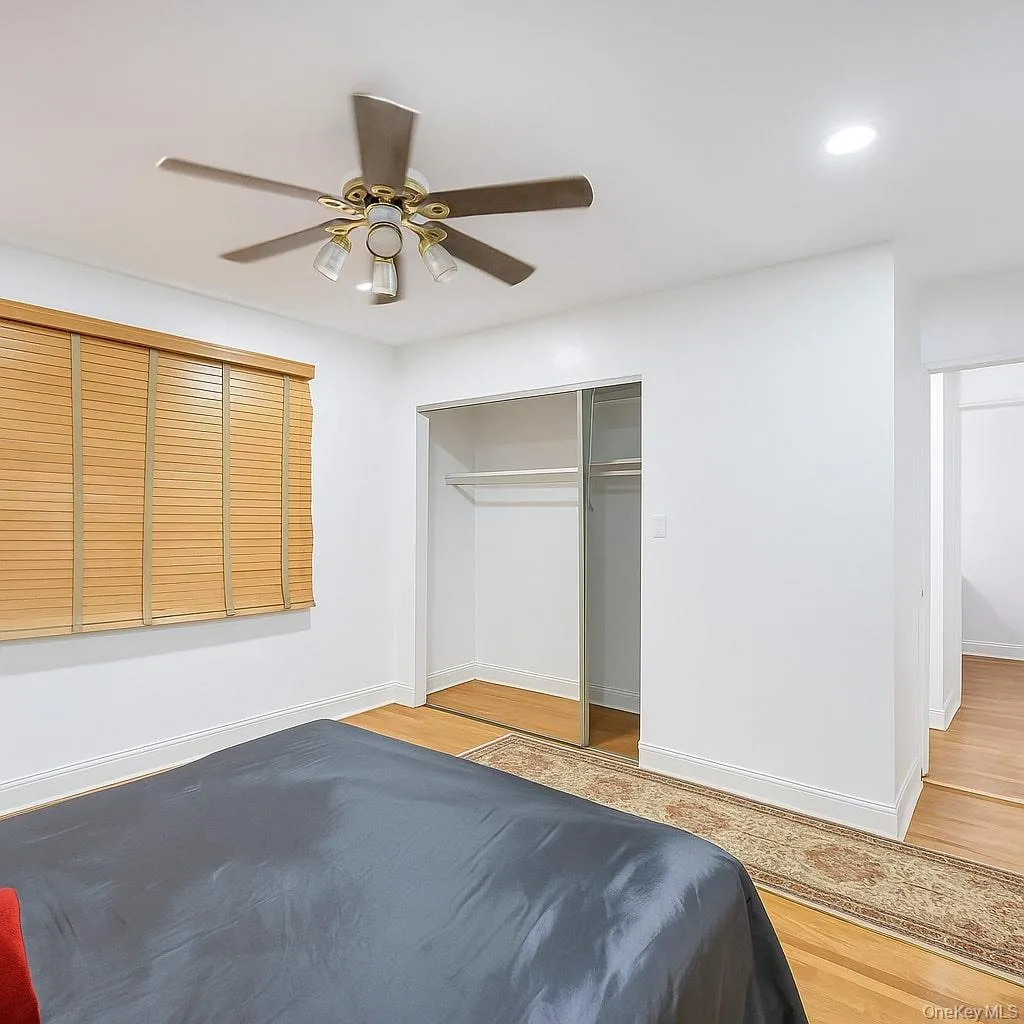 Bedroom with wood finished floors, a ceiling fan, a closet, and recessed lighting Bedroom with wood finished floors, a ceiling fan, a closet, and recessed lighting