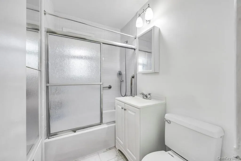 Bathroom with vanity and bath / shower combo with glass door Bathroom with vanity and bath / shower combo with glass door