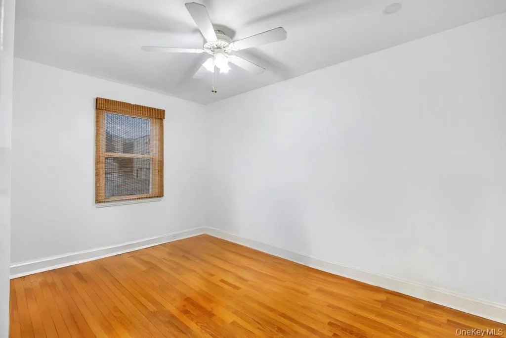 Unfurnished bedroom with light wood-style floors and a ceiling fan Unfurnished bedroom with light wood-style floors and a ceiling fan
