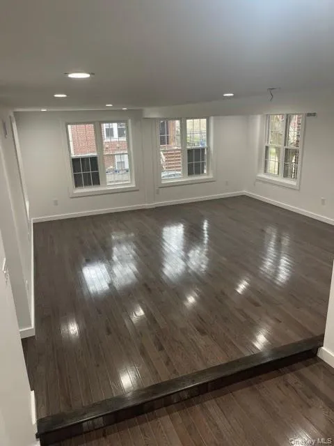 Living room featuring dark wood-style flooring Living room featuring dark wood-style flooring