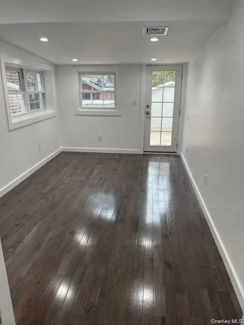 Bedroom featuring plenty of natural light, dark wood-type flooring, and recessed lighting. Access to the patio Bedroom featuring plenty of natural light, dark wood-type flooring, and recessed lighting. Access to the patio