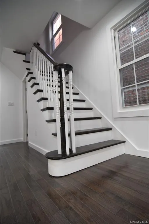 Staircase featuring wood finished floors and baseboards Staircase featuring wood finished floors and baseboards