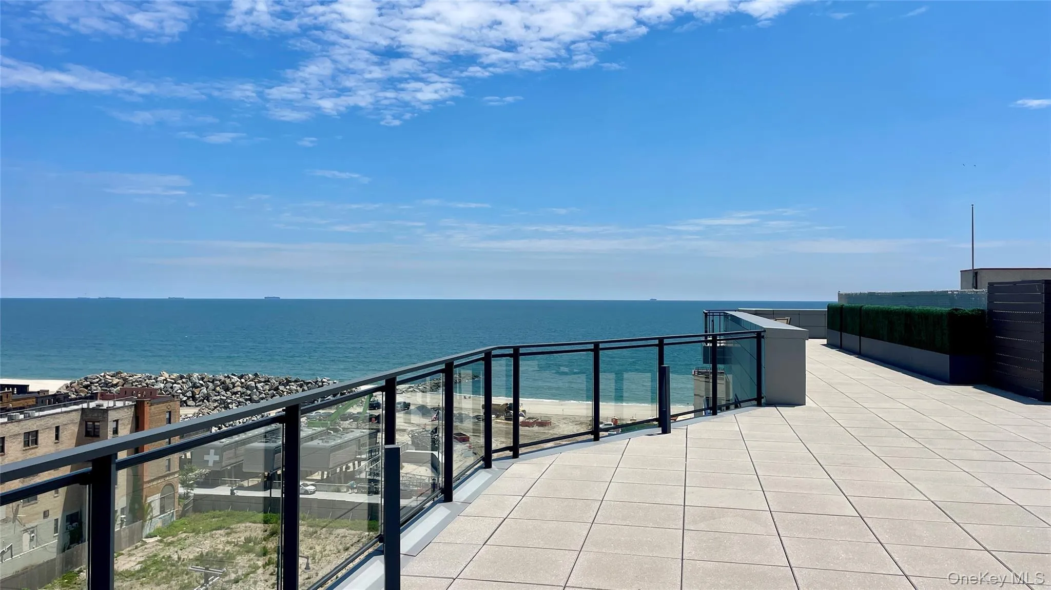 Balcony with view of water and beach Balcony with view of water and beach