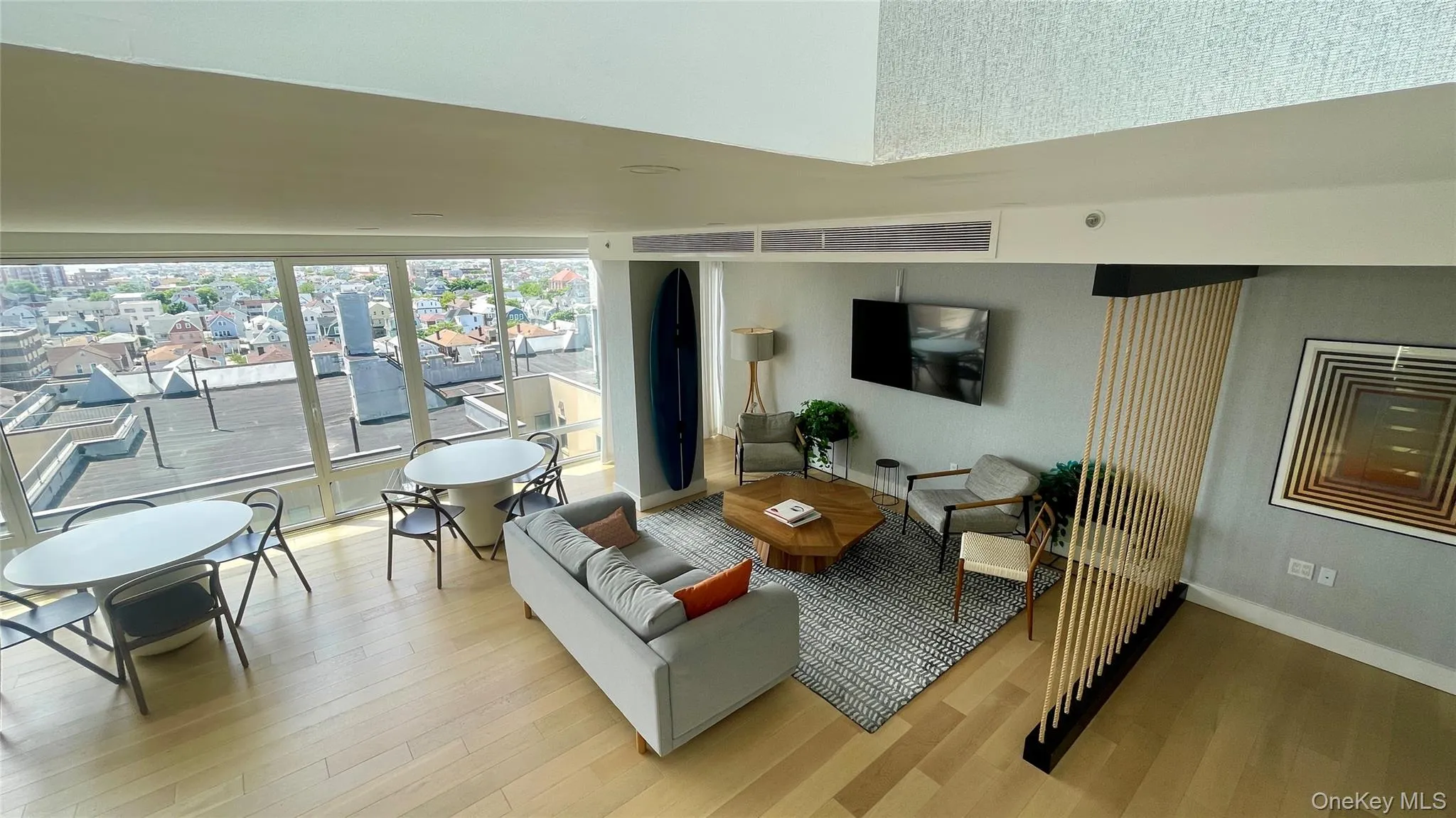 Living area featuring light wood-style floors and baseboards Living area featuring light wood-style floors and baseboards