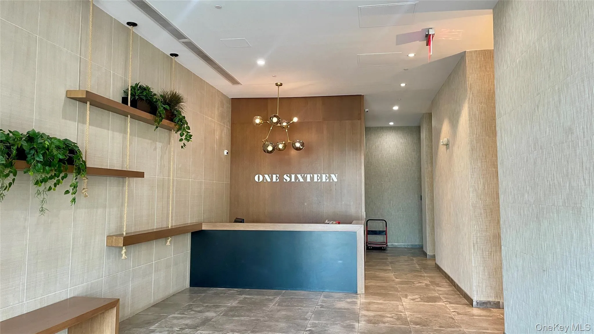 Welcome area featuring a chandelier, tile walls, and recessed lighting Welcome area featuring a chandelier, tile walls, and recessed lighting