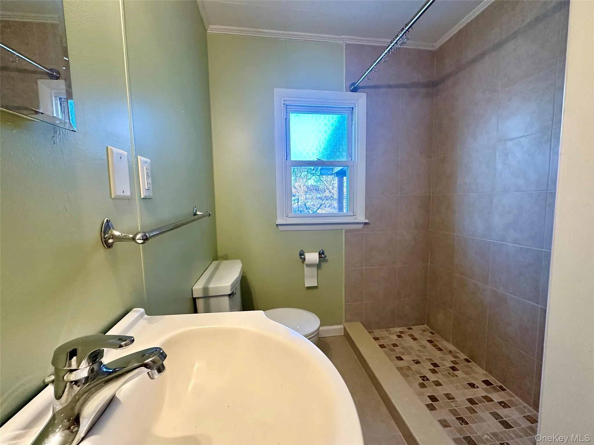 Bathroom with a stall shower and ornamental molding Bathroom with a stall shower and ornamental molding