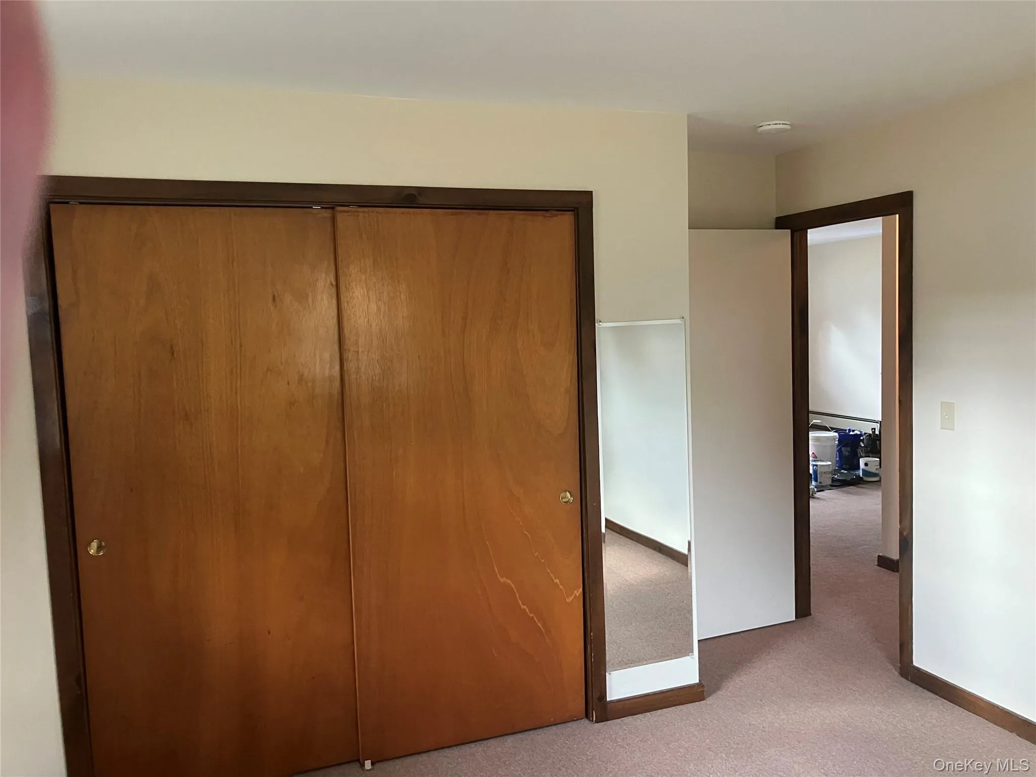Unfurnished bedroom with carpet floors and a closet Unfurnished bedroom with carpet floors and a closet