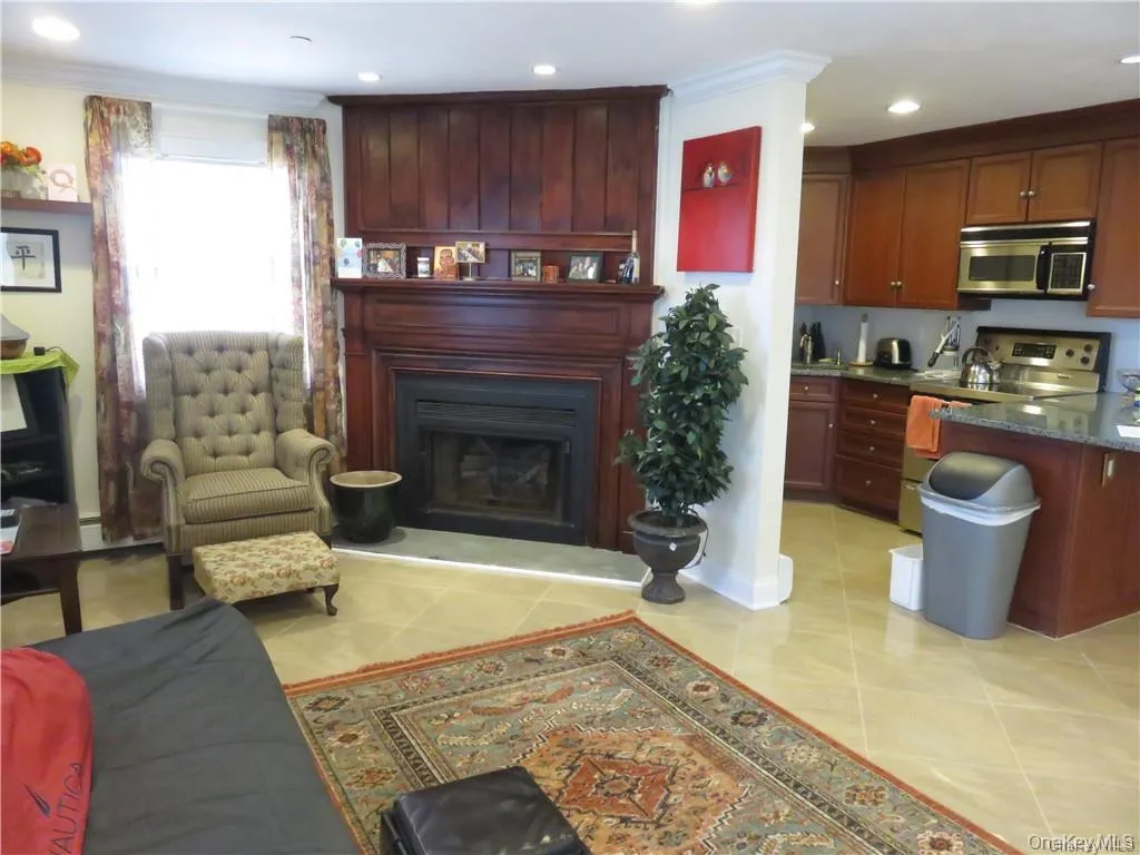 Living room featuring a fireplace, light tile patterned floors, and recessed lighting Living room featuring a fireplace, light tile patterned floors, and recessed lighting