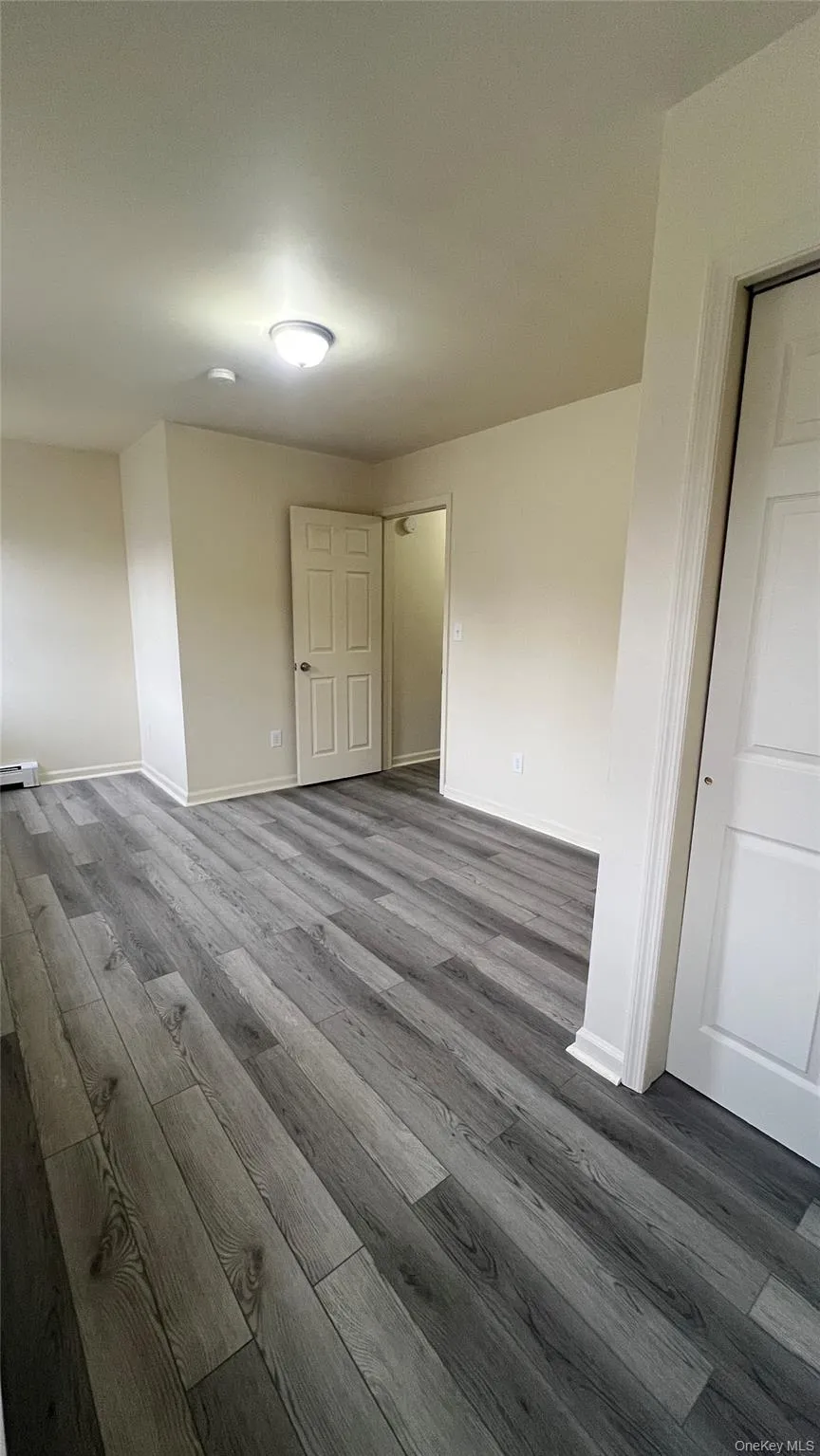 Bedroom 2 featuring wood-style floors and baseboards Bedroom 2 featuring wood-style floors and baseboards