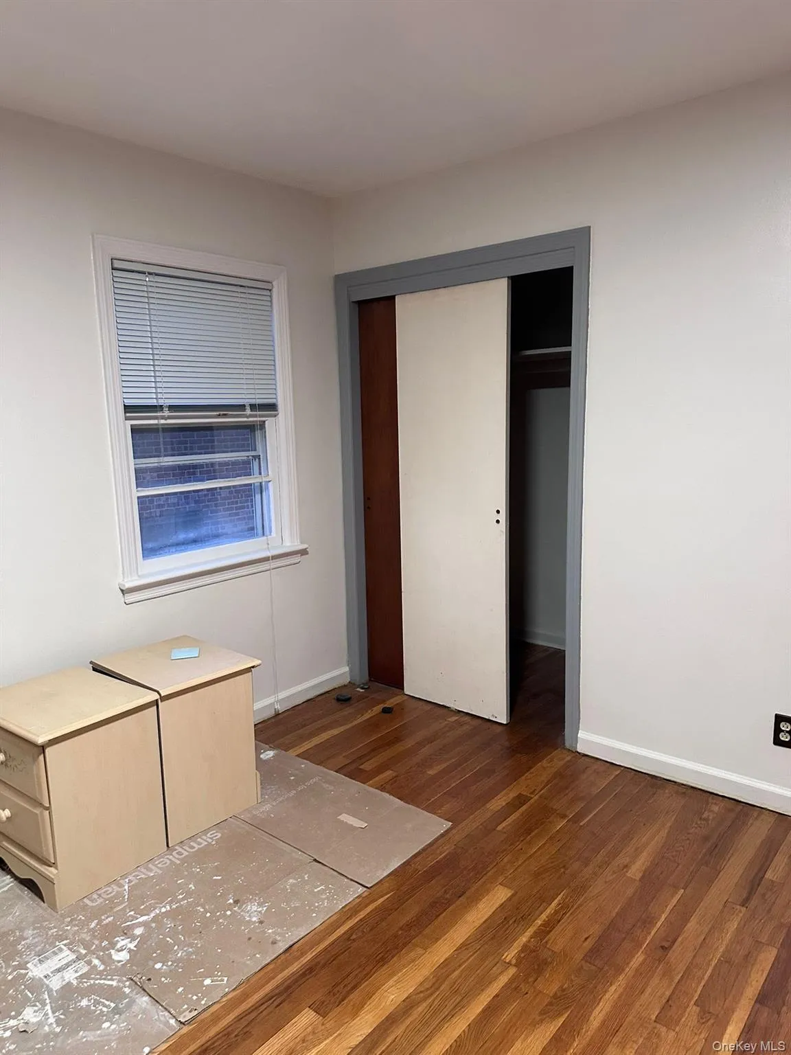 Unfurnished bedroom with wood finished floors and a closet Unfurnished bedroom with wood finished floors and a closet