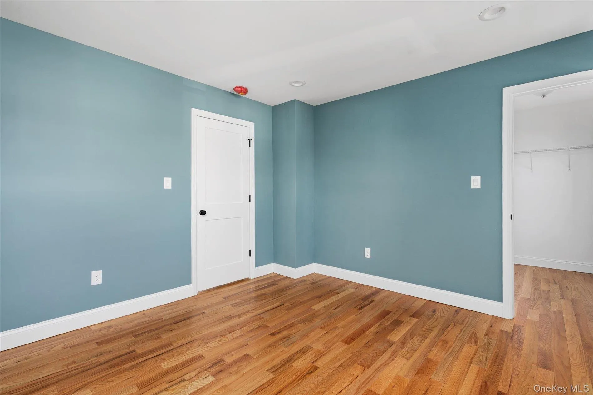 Unfurnished room featuring wood finished floors Unfurnished room featuring wood finished floors