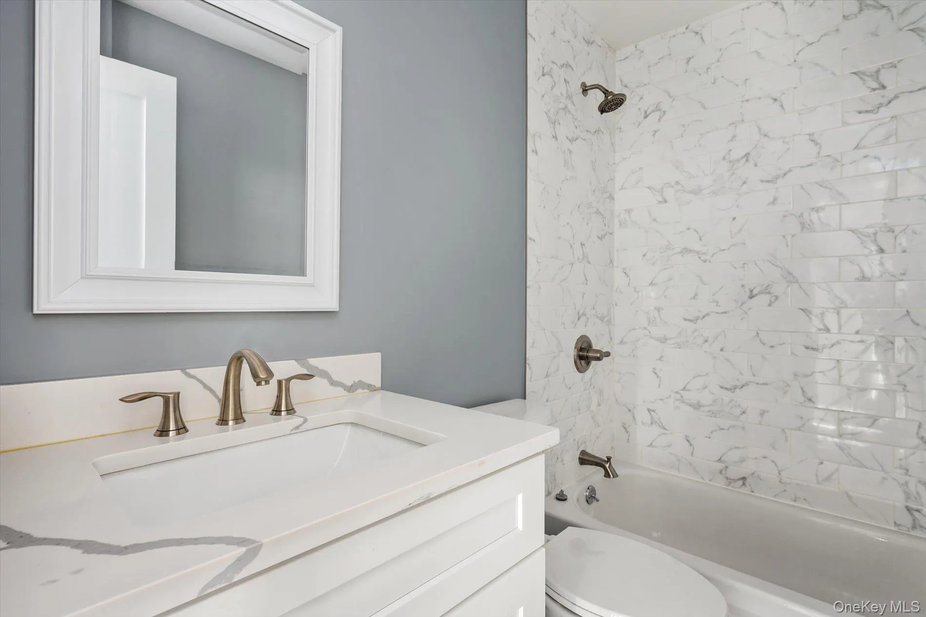 Full bathroom with vanity and shower / bath combination Full bathroom with vanity and shower / bath combination