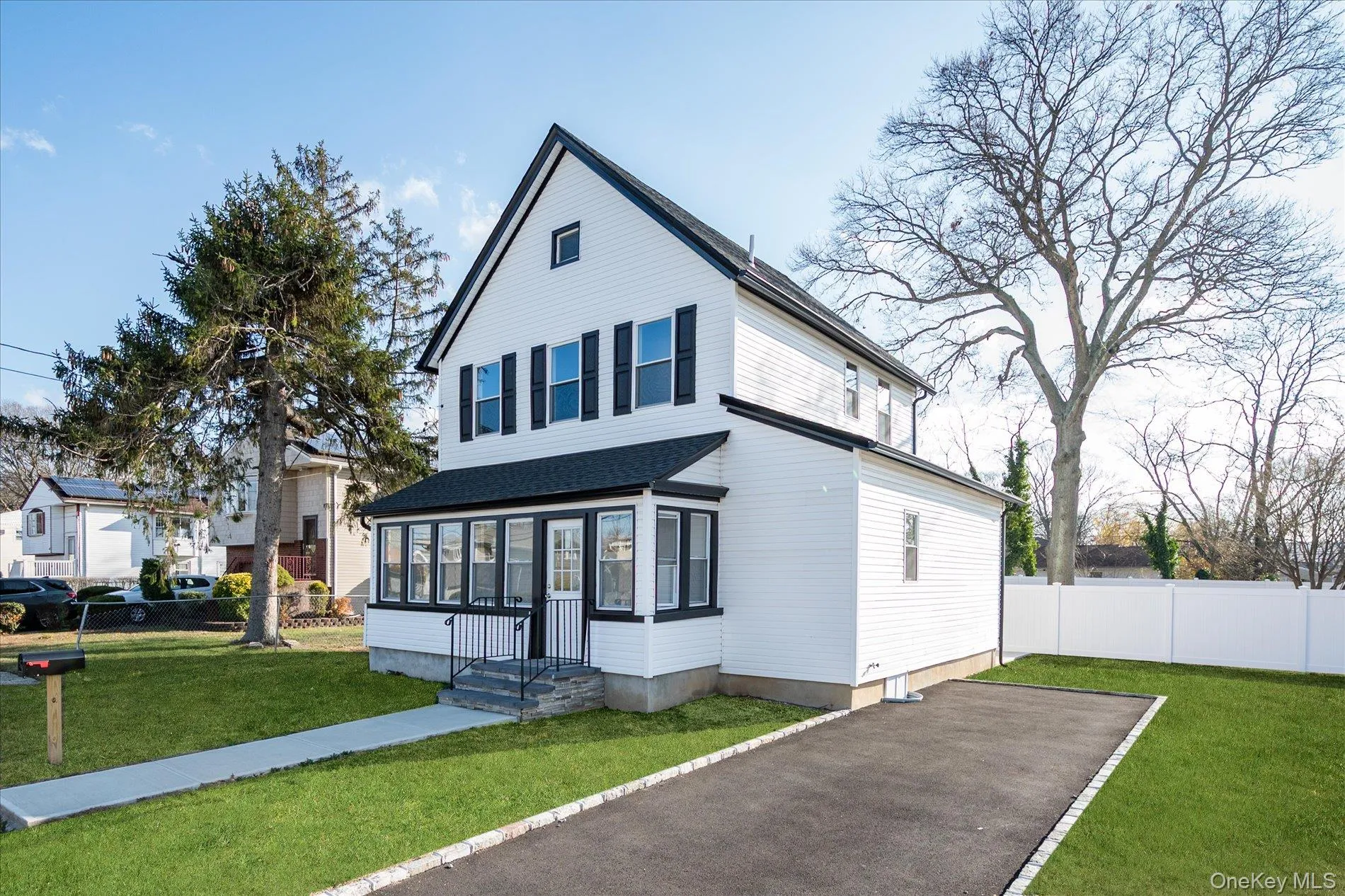 View of front of house featuring a sunroom View of front of house featuring a sunroom