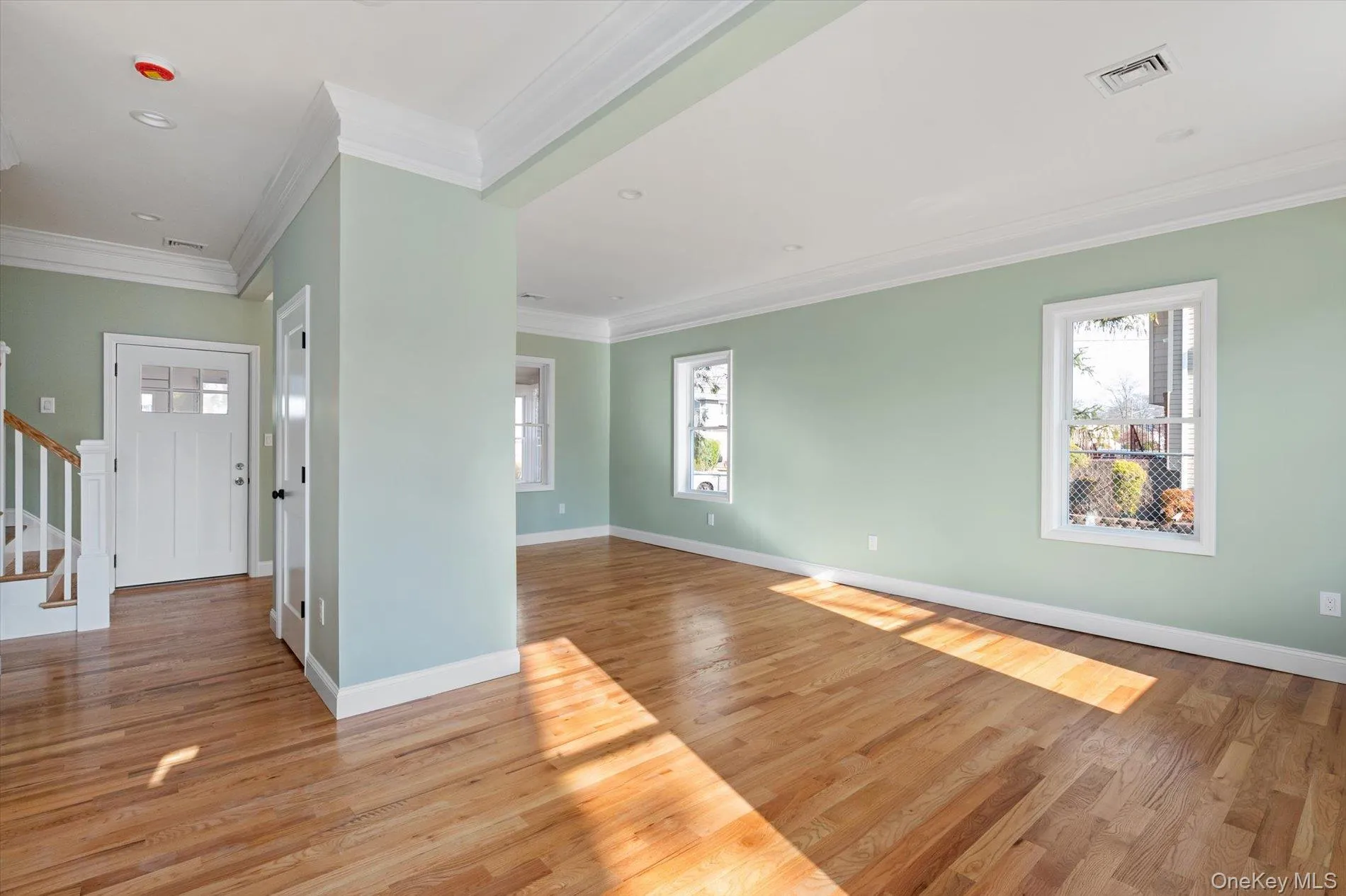 Foyer with stairs, crown molding, light wood-type flooring, and recessed lighting Foyer with stairs, crown molding, light wood-type flooring, and recessed lighting