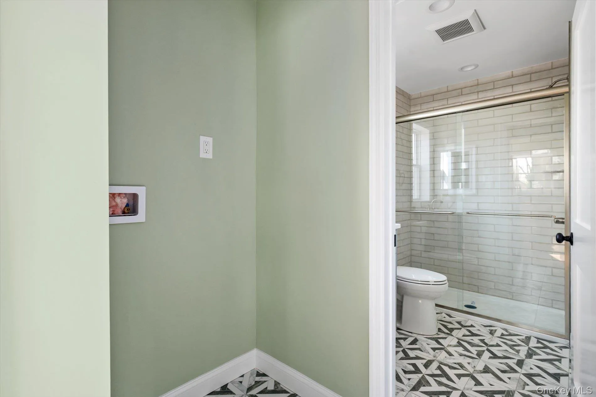 Bathroom featuring a shower stall and toilet Bathroom featuring a shower stall and toilet