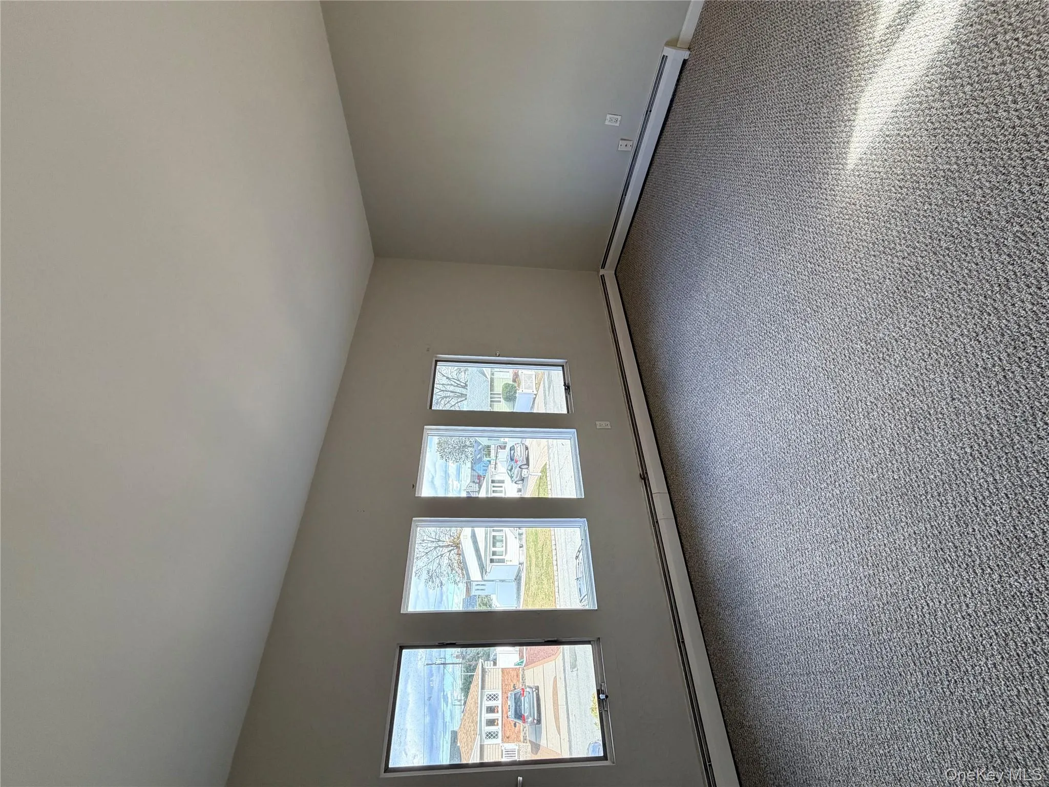 Carpeted empty room featuring baseboards and baseboard heating Carpeted empty room featuring baseboards and baseboard heating