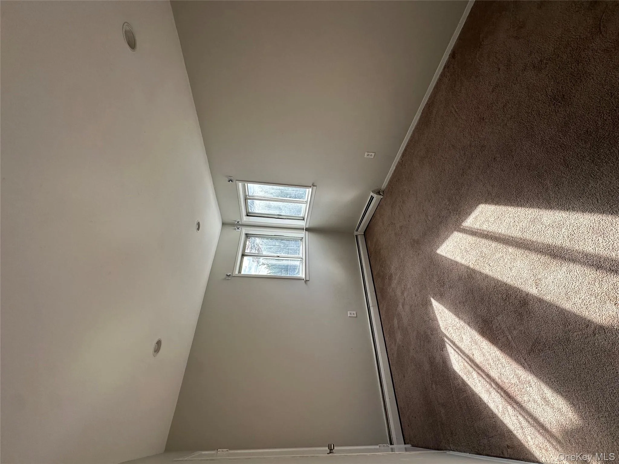 Spare room featuring baseboards and carpet flooring Spare room featuring baseboards and carpet flooring