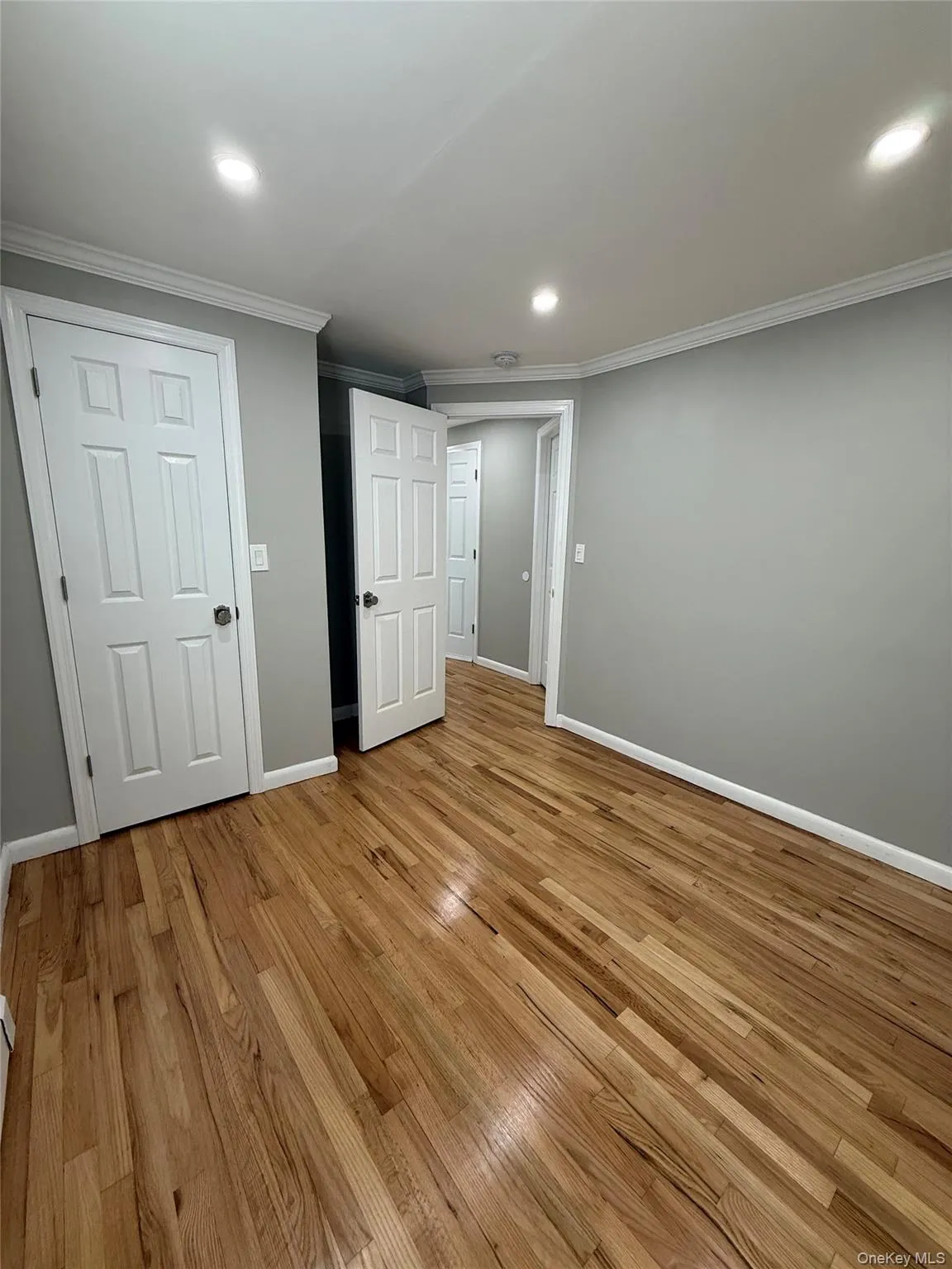 Unfurnished bedroom featuring light wood-style flooring, recessed lighting, and crown molding Unfurnished bedroom featuring light wood-style flooring, recessed lighting, and crown molding