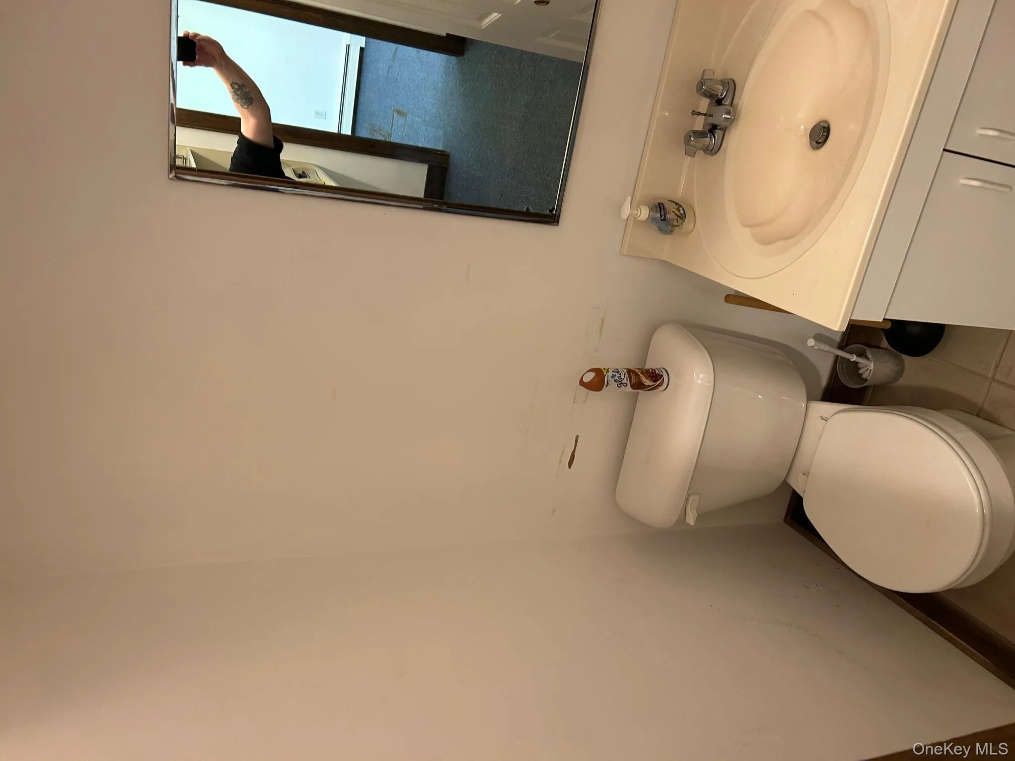 Bathroom with tile patterned floors, vanity, and a baseboard heating unit Bathroom with tile patterned floors, vanity, and a baseboard heating unit