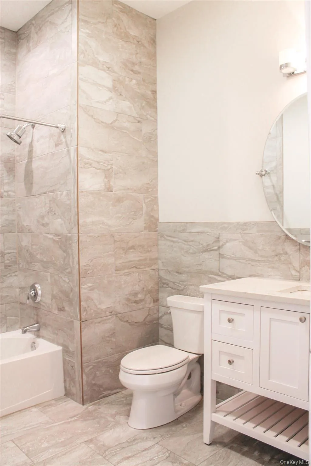 Full bath with tile walls, vanity, and shower / tub combination Full bath with tile walls, vanity, and shower / tub combination