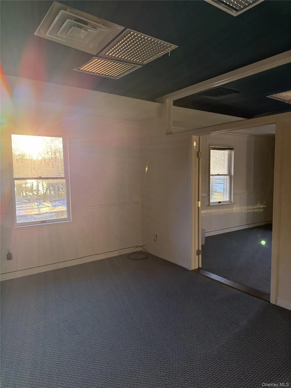 Unfurnished room featuring carpet floors and a decorative wall Unfurnished room featuring carpet floors and a decorative wall