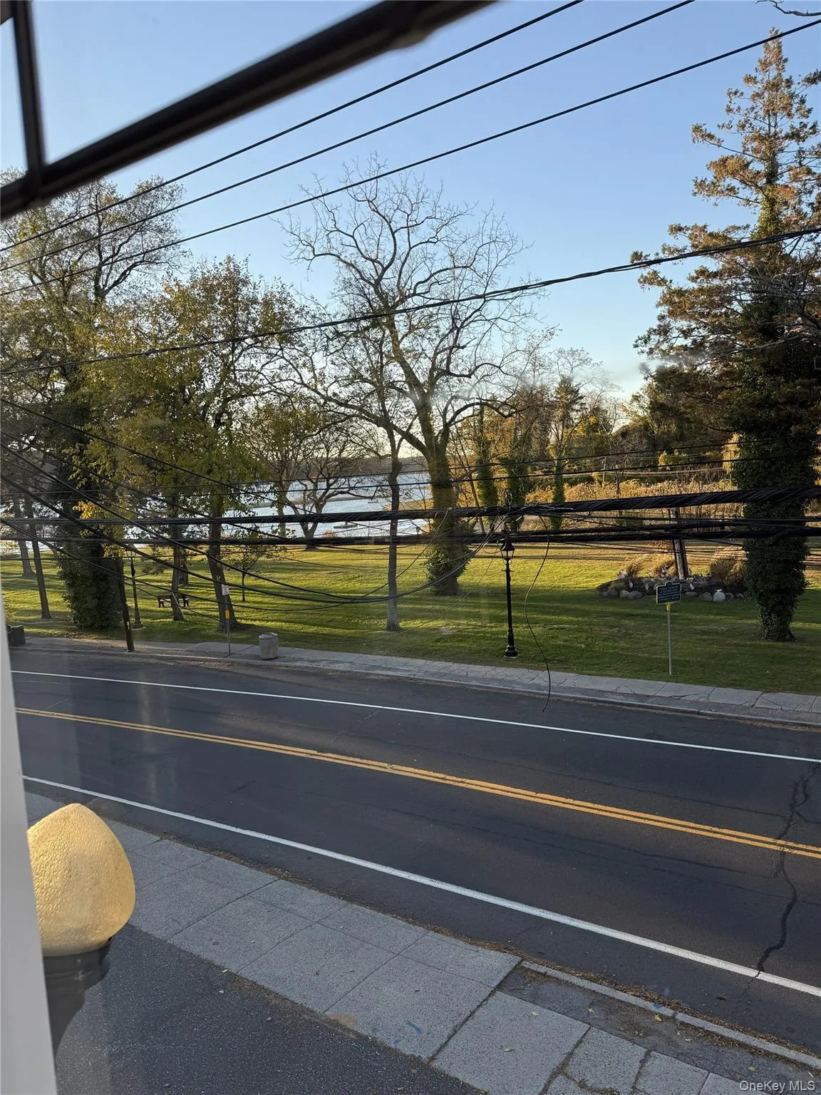 View of asphalt road with curbs and sidewalks View of asphalt road with curbs and sidewalks