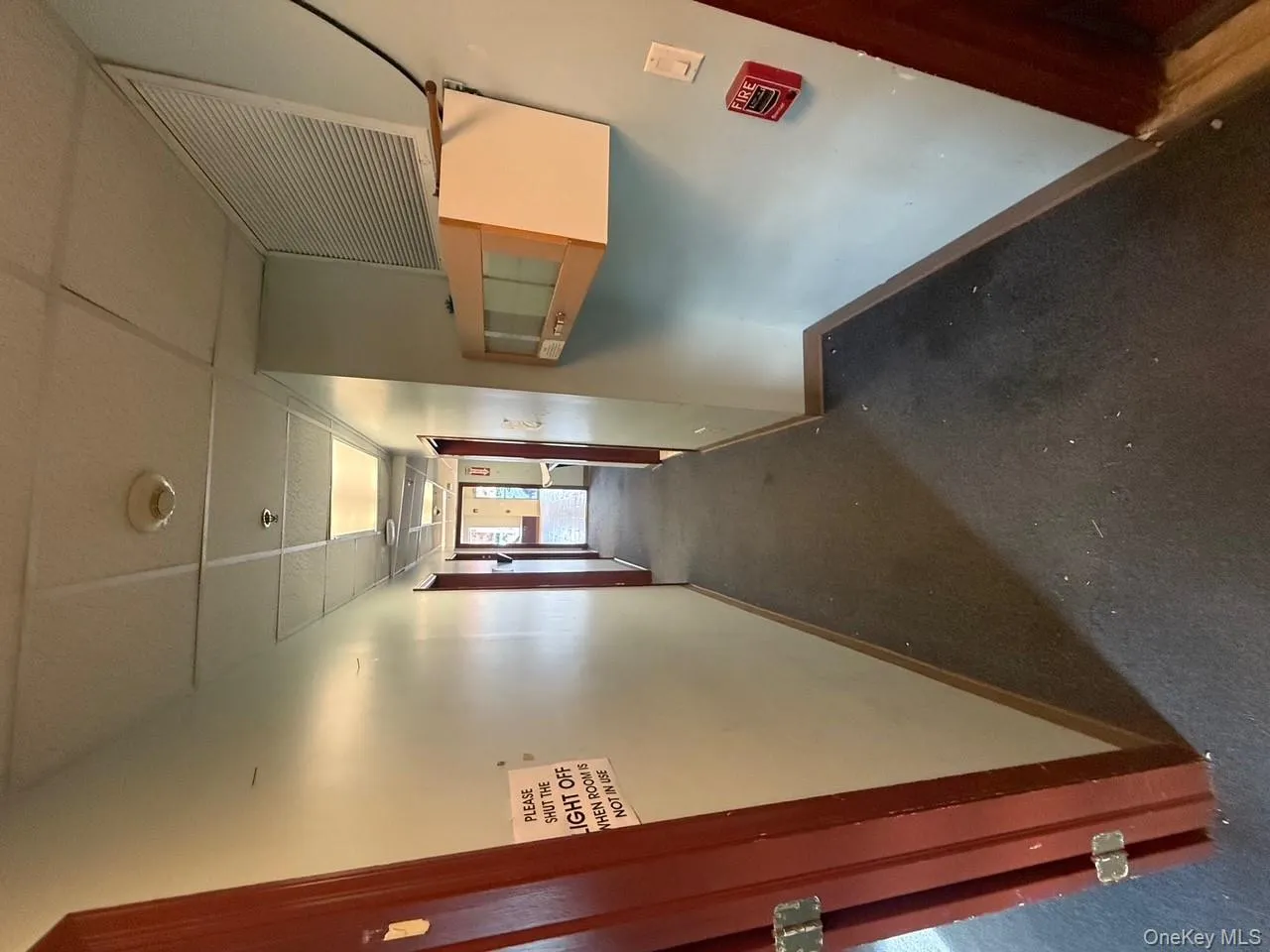 Corridor featuring a drop ceiling and carpet floors Corridor featuring a drop ceiling and carpet floors