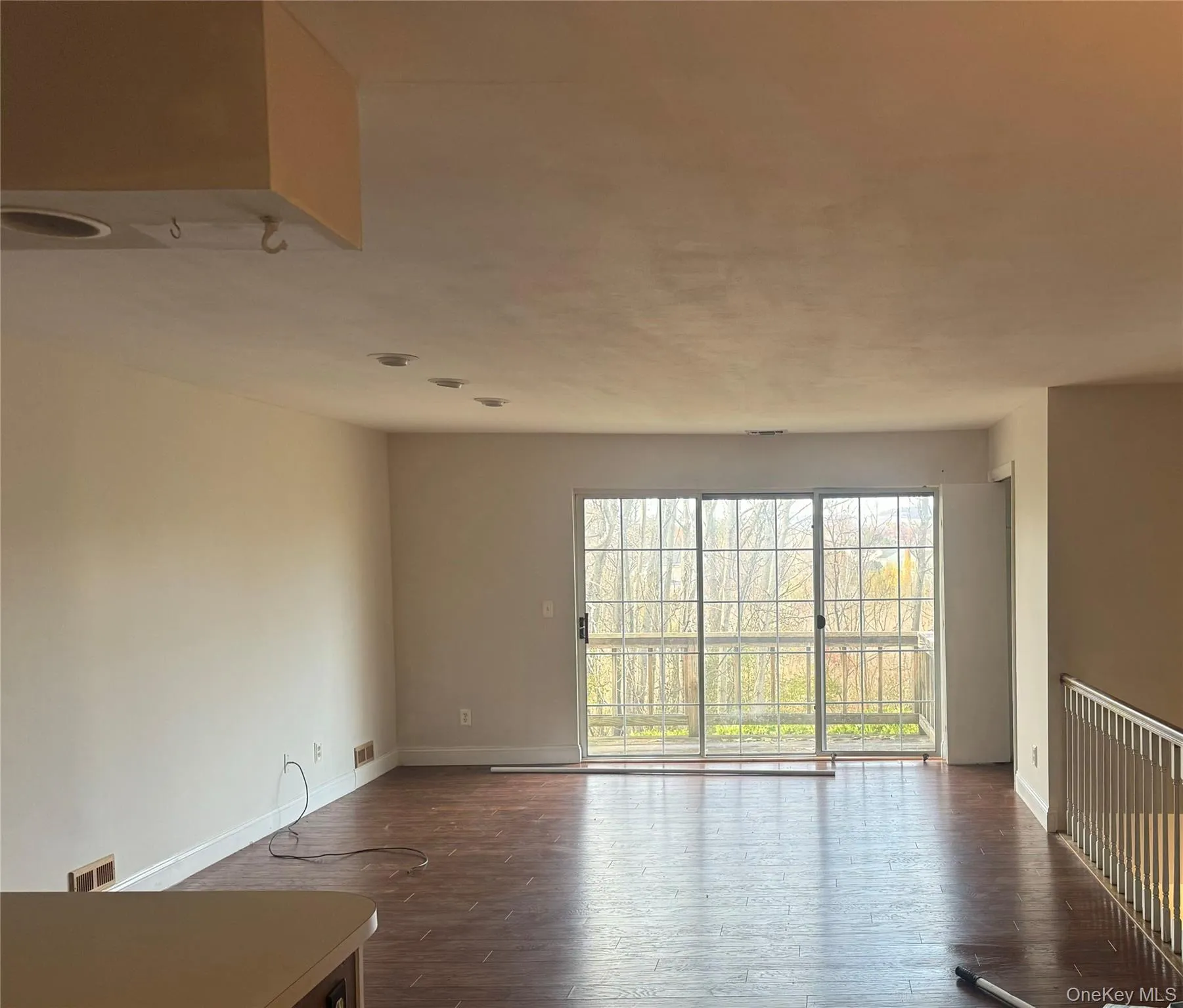 Empty room featuring dark wood-type flooring and baseboards Empty room featuring dark wood-type flooring and baseboards