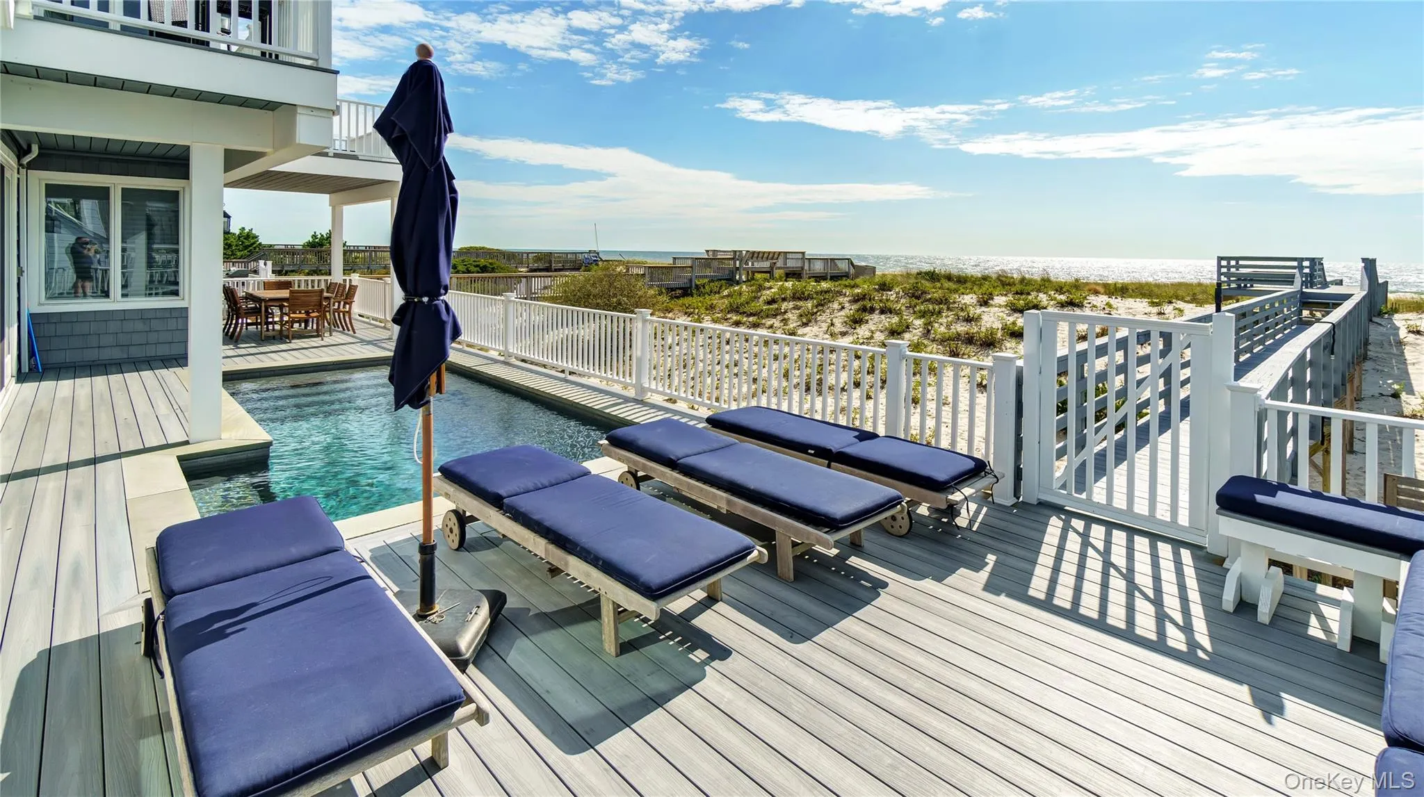 Deck with outdoor dining space and a water view Deck with outdoor dining space and a water view