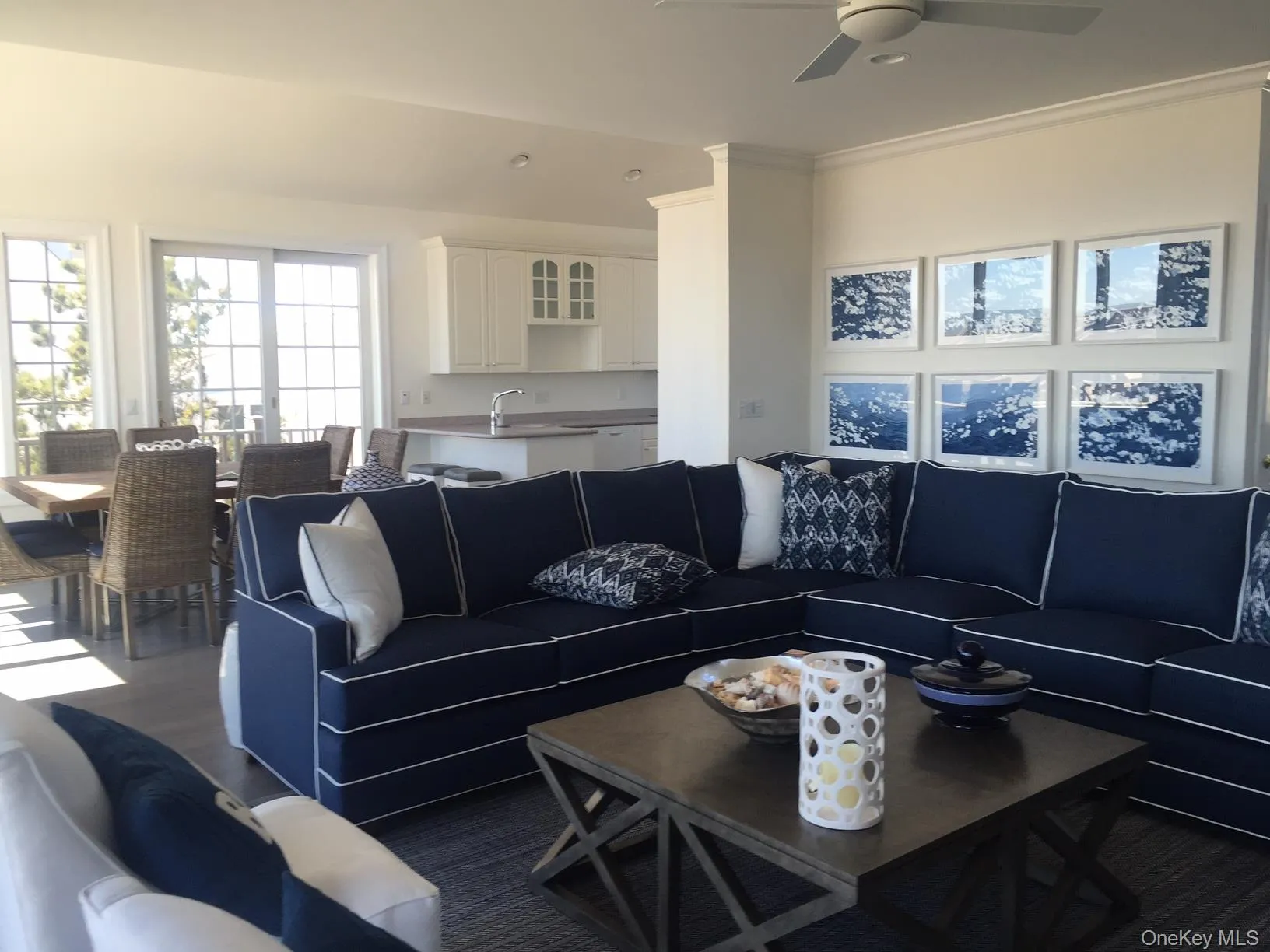 Living area with dark wood-type flooring and ornamental molding Living area with dark wood-type flooring and ornamental molding