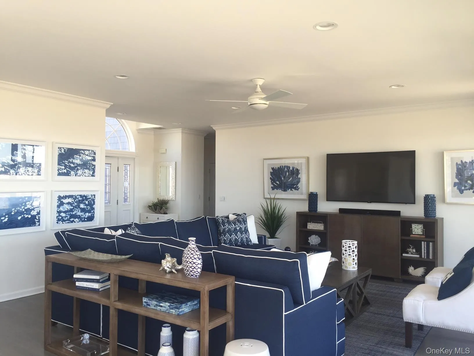 Living area with crown molding, ceiling fan, and recessed lighting Living area with crown molding, ceiling fan, and recessed lighting