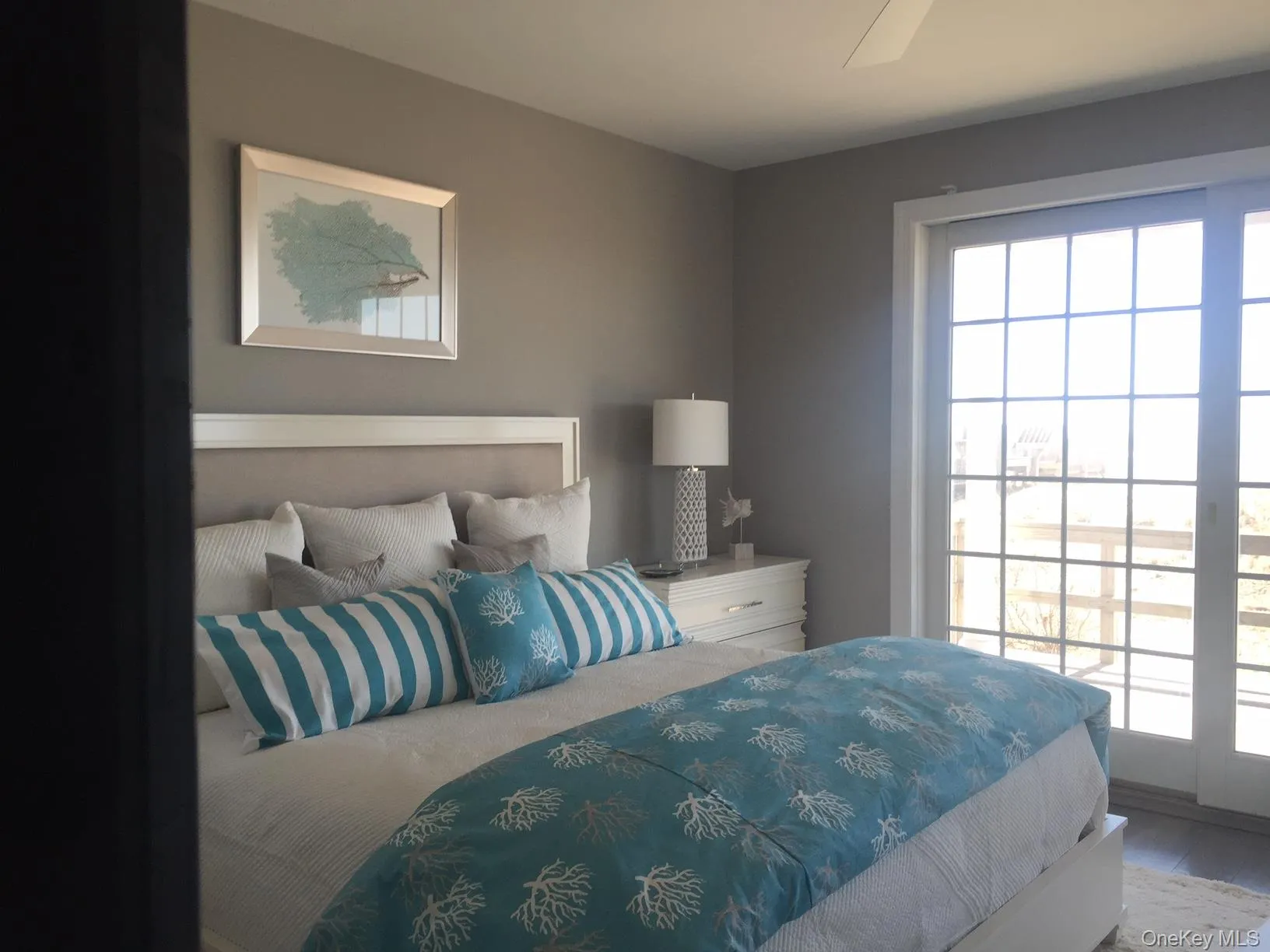 Bedroom with multiple windows, wood finished floors, and a ceiling fan Bedroom with multiple windows, wood finished floors, and a ceiling fan