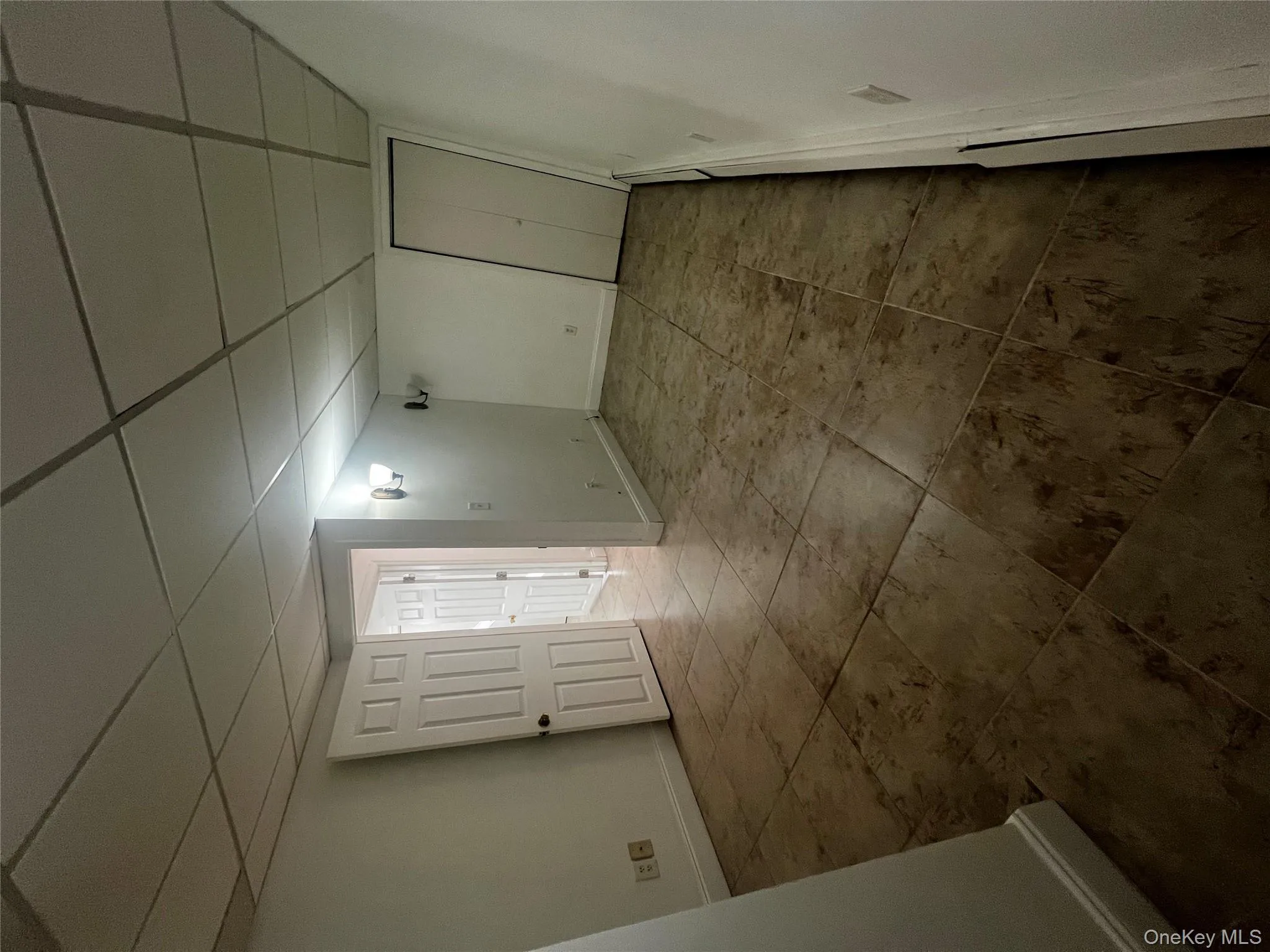 Spare room with a drop ceiling and tile patterned floors Spare room with a drop ceiling and tile patterned floors