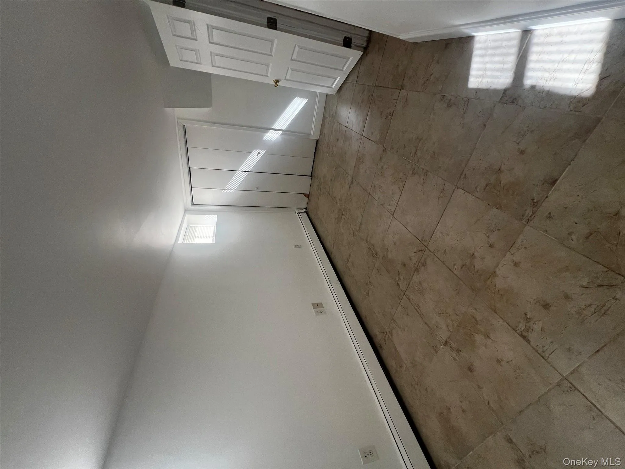 Unfurnished bedroom with baseboard heating and a closet Unfurnished bedroom with baseboard heating and a closet