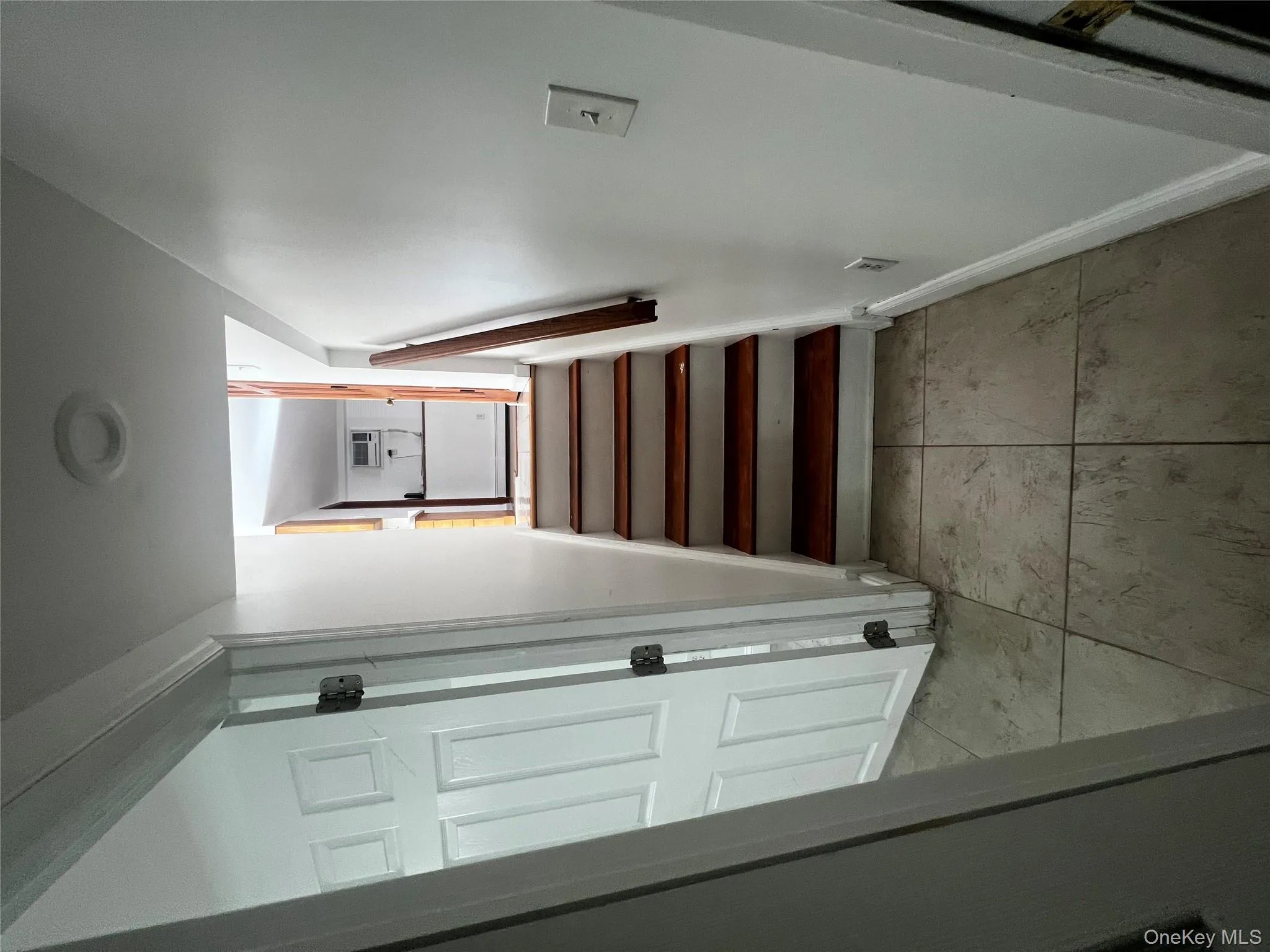 Stairway with baseboards and a wall mounted AC Stairway with baseboards and a wall mounted AC