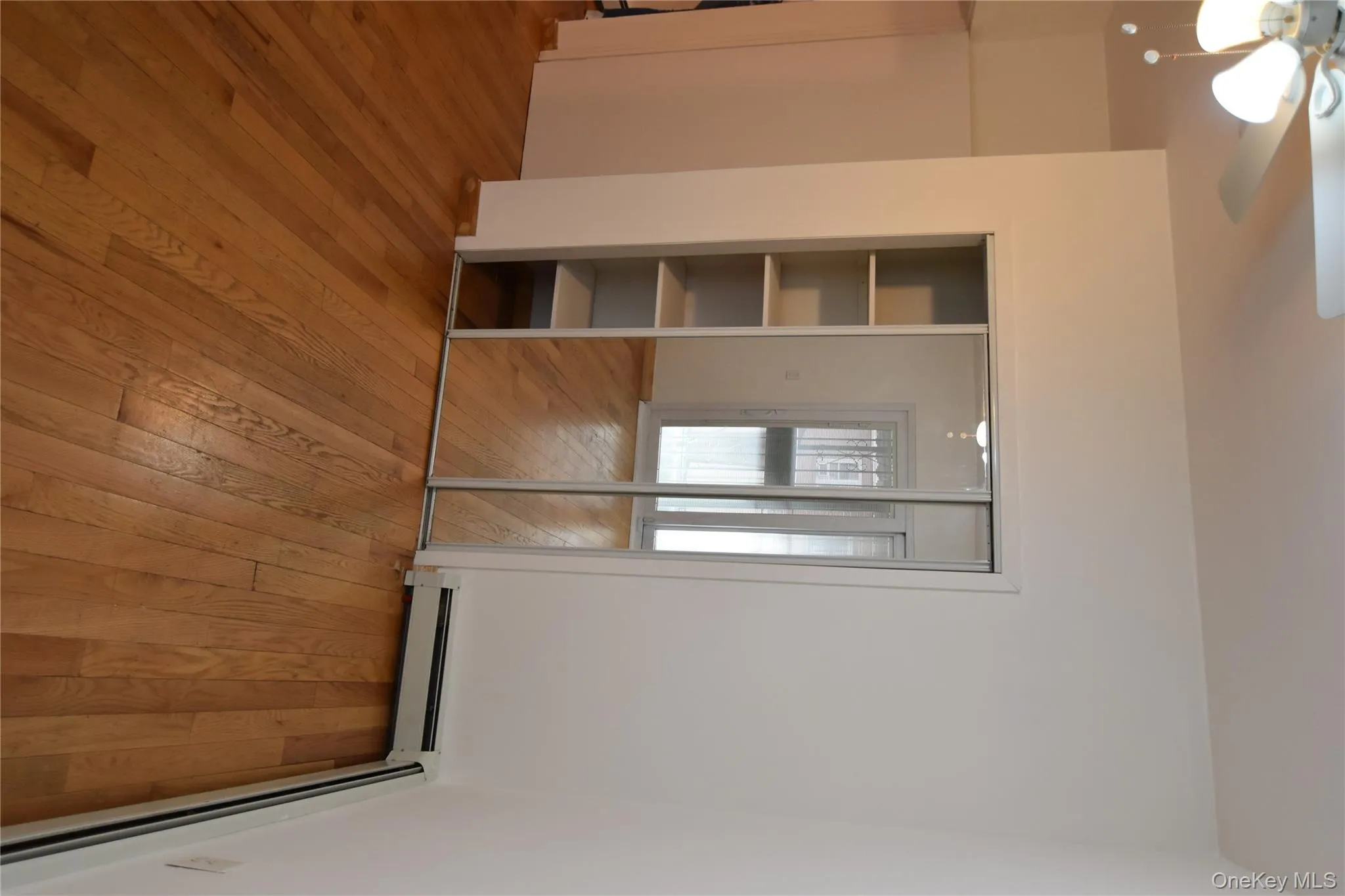 Unfurnished bedroom with a baseboard heating unit, light wood-style flooring, a closet, and ceiling fan Unfurnished bedroom with a baseboard heating unit, light wood-style flooring, a closet, and ceiling fan