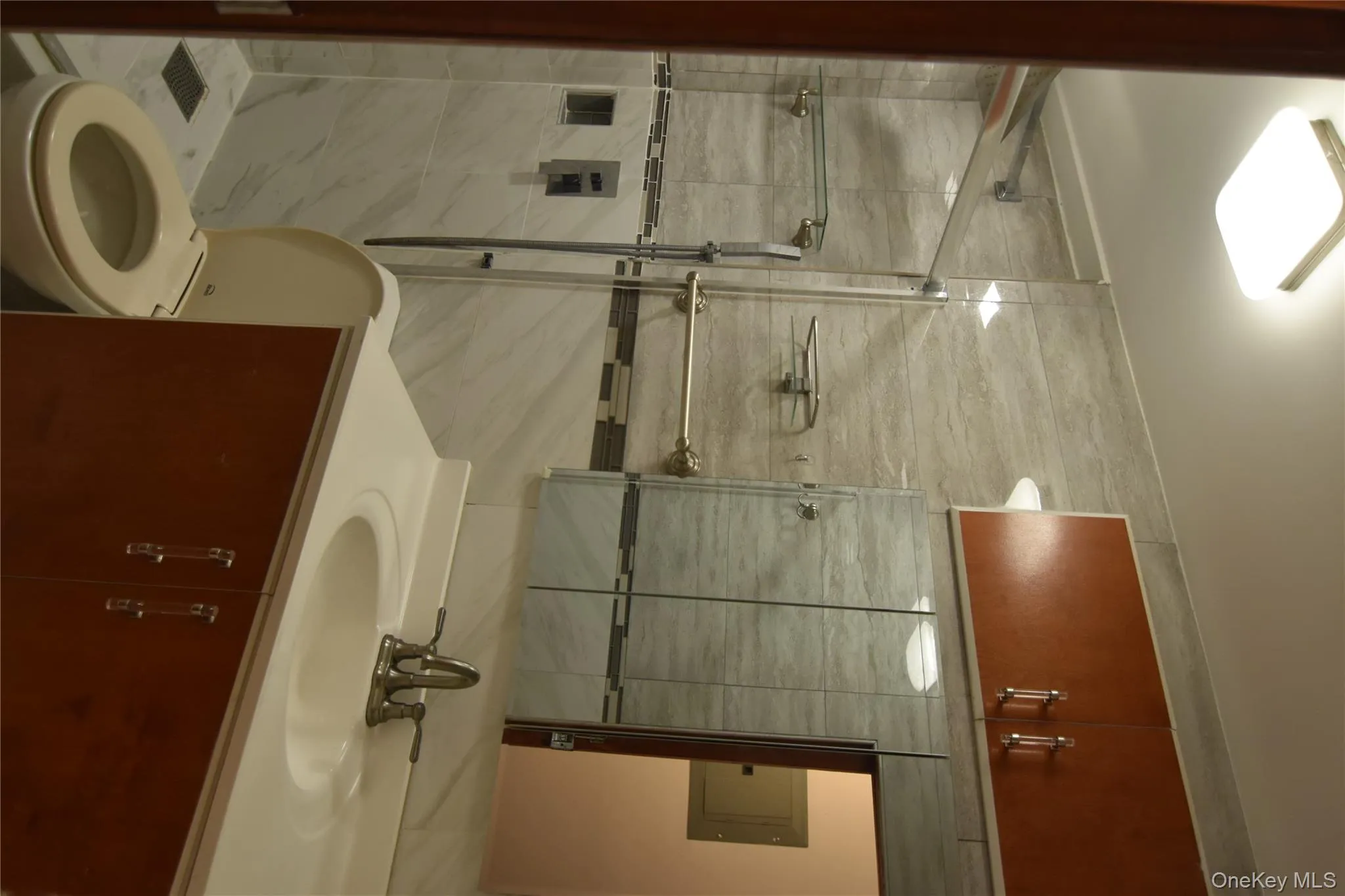 Full bath with vanity, electric panel, and a shower stall Full bath with vanity, electric panel, and a shower stall