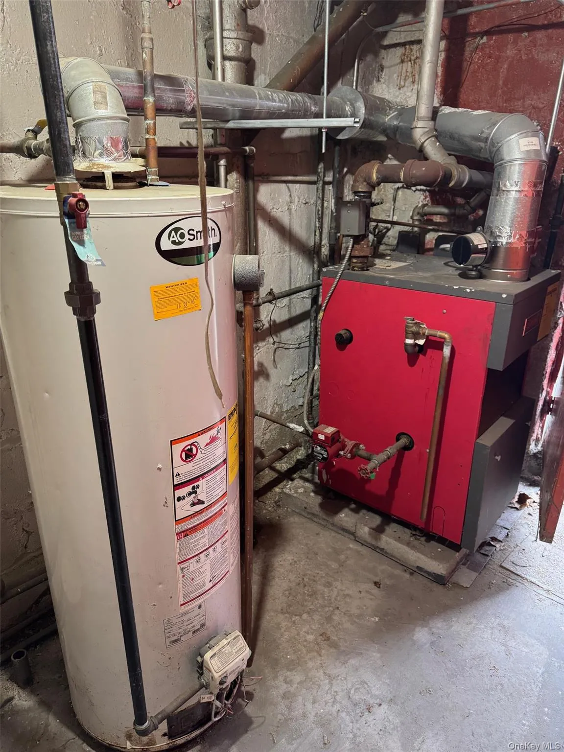 Utility room with gas water heater and a heating unit Utility room with gas water heater and a heating unit