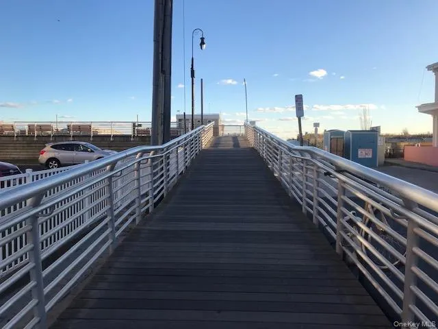 View of home's community with a pier View of home's community with a pier