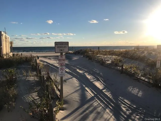 View of property's community with view of water and beach View of property's community with view of water and beach