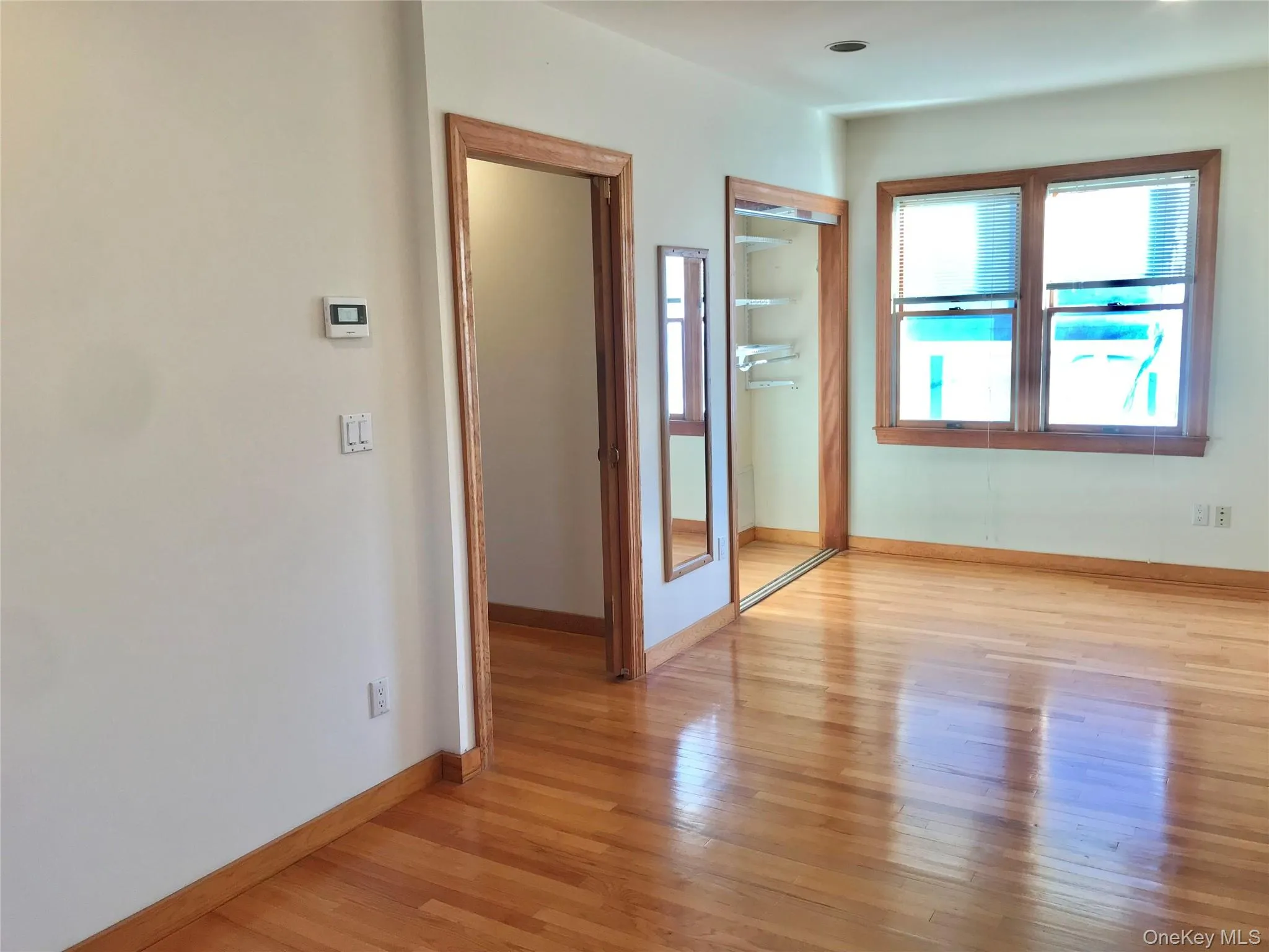 Unfurnished bedroom with a closet and light wood-style flooring Unfurnished bedroom with a closet and light wood-style flooring