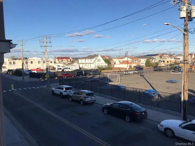 View of asphalt street with a residential view, sidewalks, curbs, and street lighting View of asphalt street with a residential view, sidewalks, curbs, and street lighting