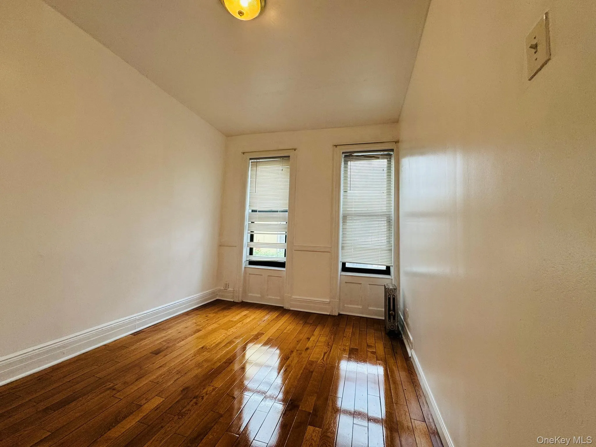 Empty room with hardwood / wood-style flooring and baseboards Empty room with hardwood / wood-style flooring and baseboards