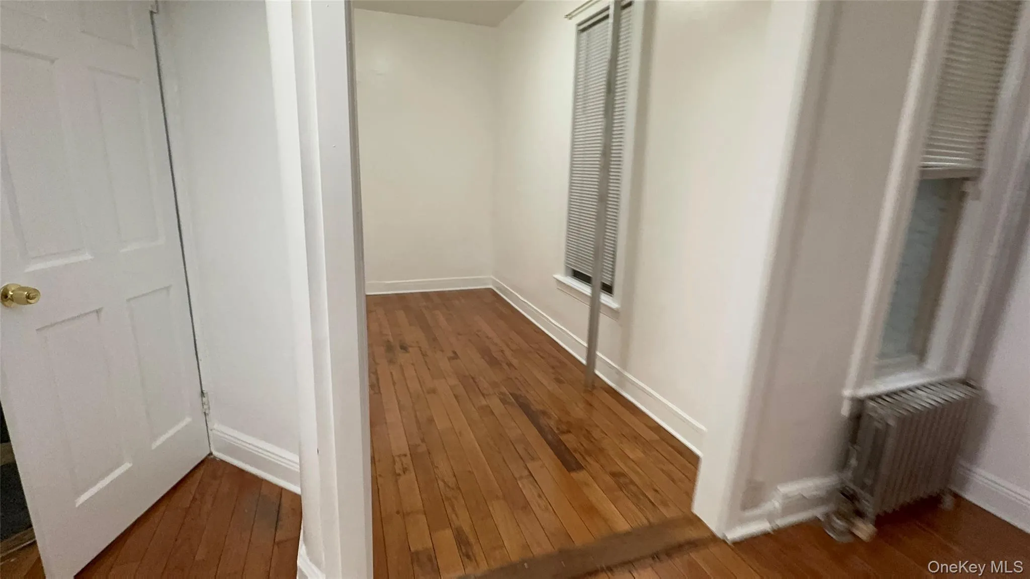 Hall featuring dark wood-style floors and baseboards Hall featuring dark wood-style floors and baseboards