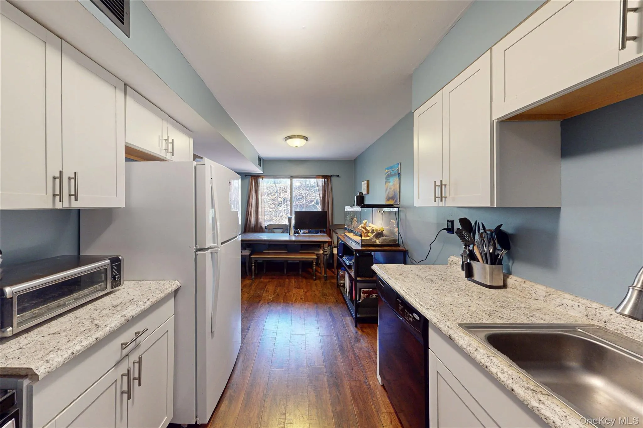 Updated Kitchen featuring white cabinetry and breakfast nook Updated Kitchen featuring white cabinetry and breakfast nook