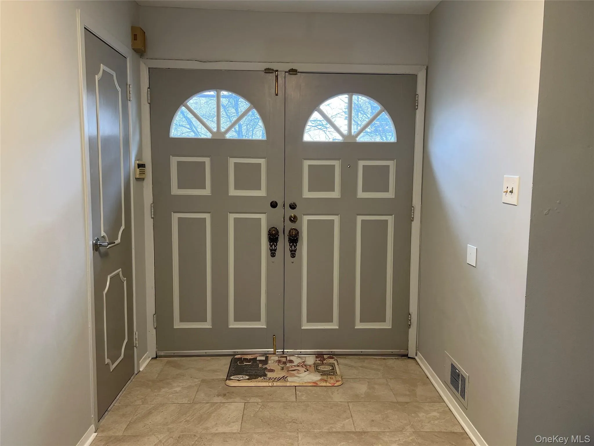 Foyer entrance featuring baseboards Foyer entrance featuring baseboards