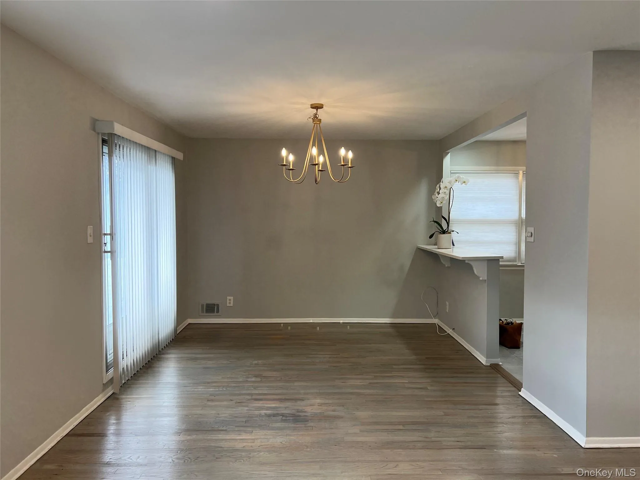 Dining Room with dark wood-style floors and a chandelier Dining Room with dark wood-style floors and a chandelier