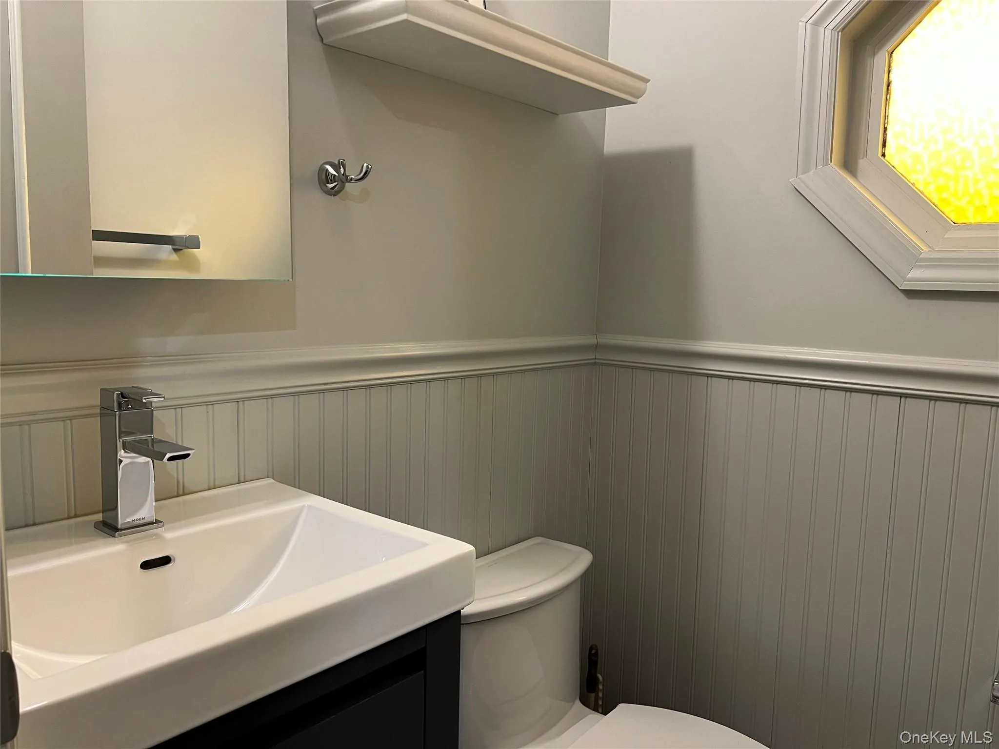 Half bath with a wainscoted wall Half bath with a wainscoted wall