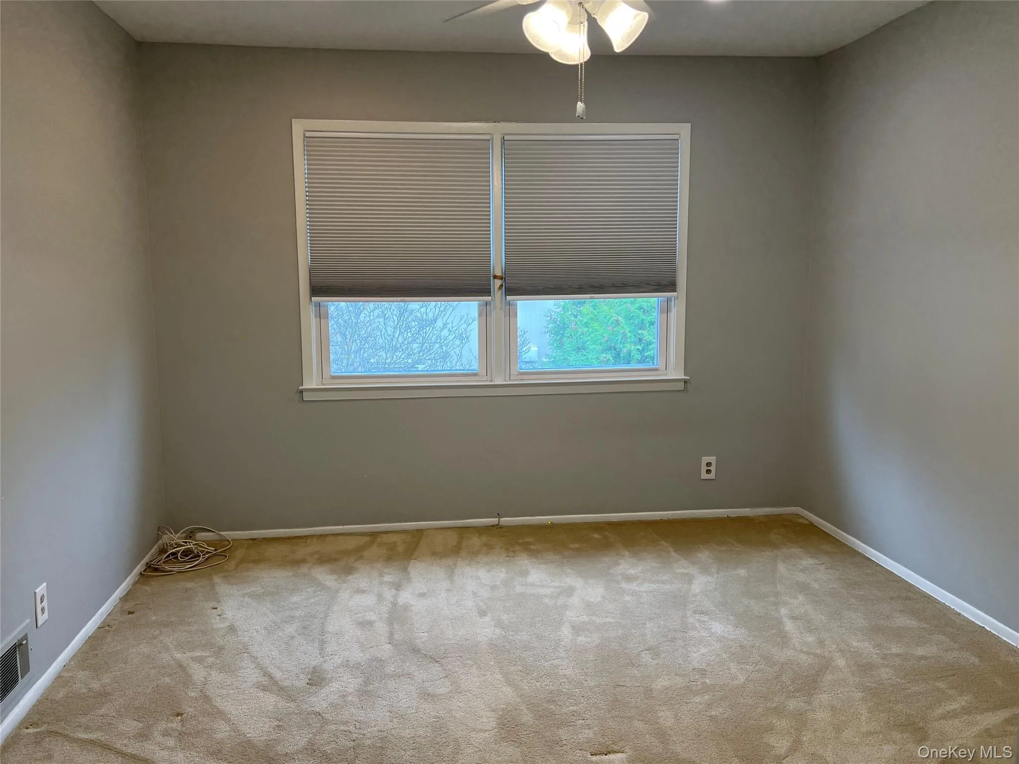 2nd Bedroom with light colored carpet and a ceiling fan 2nd Bedroom with light colored carpet and a ceiling fan